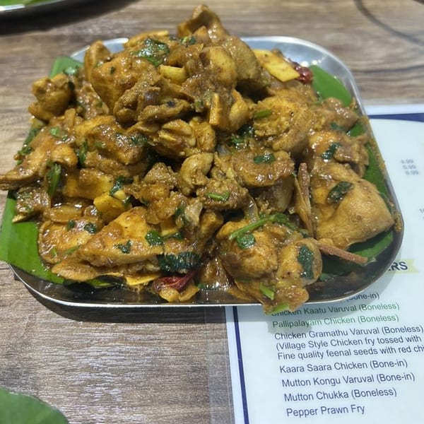 Kuppanna's Chicken Gramathu Varuval, a South Indian chicken fry, served on a banana leaf.
